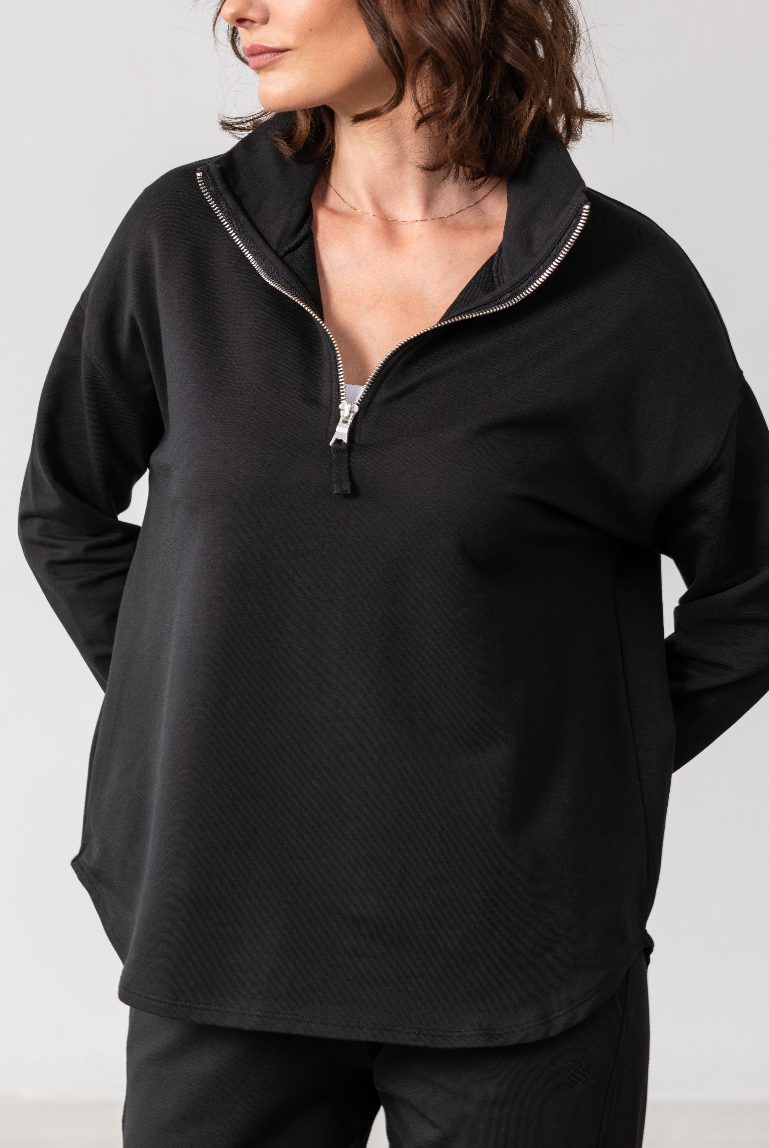 Women shown wearing Black Quarter zip pullover